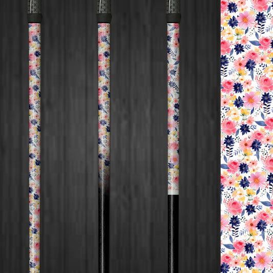 A golf club with a vinyl shaft wrap featuring pink and yellow flowers on a white background. The wrap is smoothly applied, adding a bright and custom look to the club. The floral design highlights the easy application and the fresh, cheerful style it brings to the golf shaft.